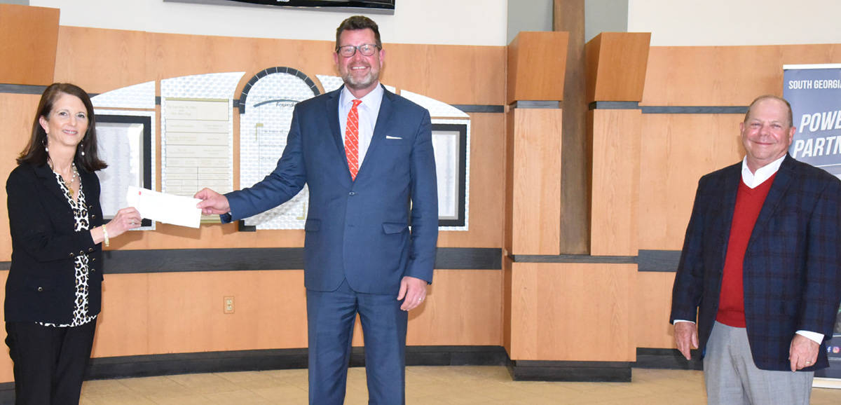 Shown above (l to r) are: Tami Duke of Synovus presenting SGTC President Dr. John Watford with a donation for the South Georgia Technical College Foundation with Buddy Guth of Synovus looking on.