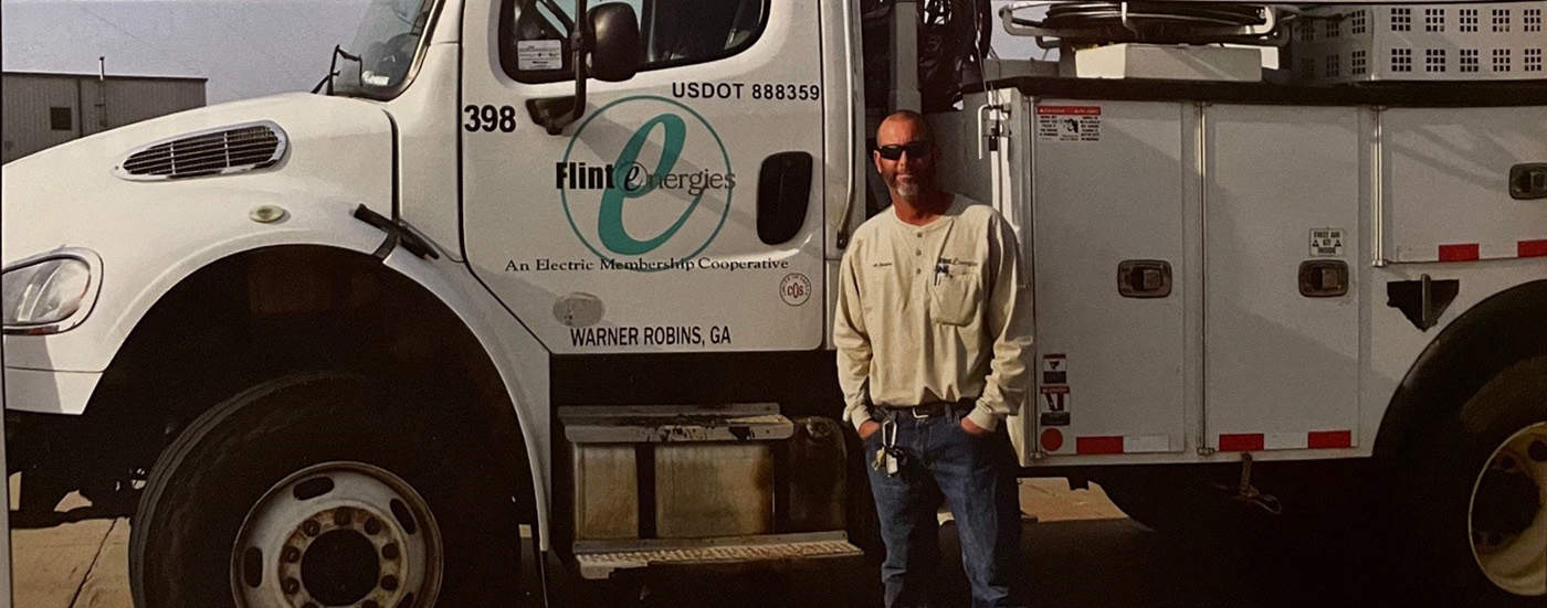 Al Jordon is shown above in front of his Flint Energies service truck.
