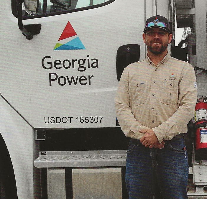 SGTC Alumni Blake Thomas is shown in front of his Georgia Power Electrical Lineworker truck.