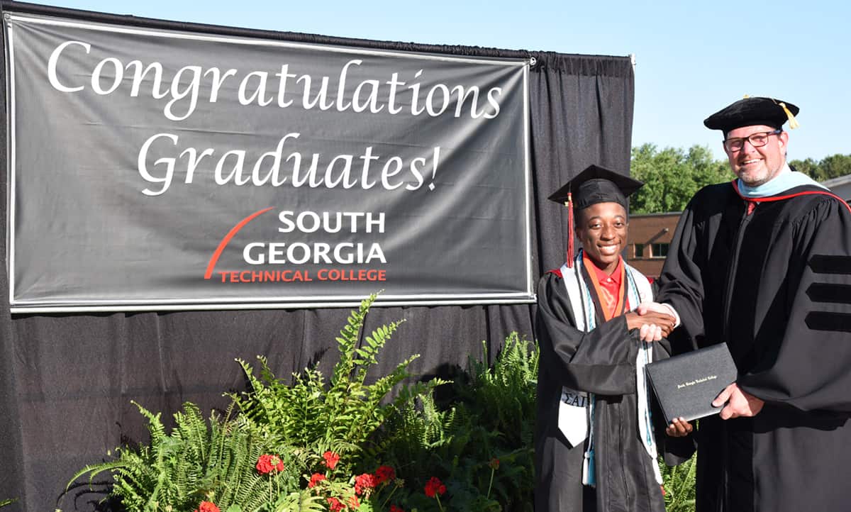 South Georgia Technical College President Dr. John Watford (right) is shown above with Chance Simpson of Macon County. Simpson received his associate degree in Computer Information System Technology before he walked at the Macon County High School graduation. He has also already been accepted into Johns Hopkins University.