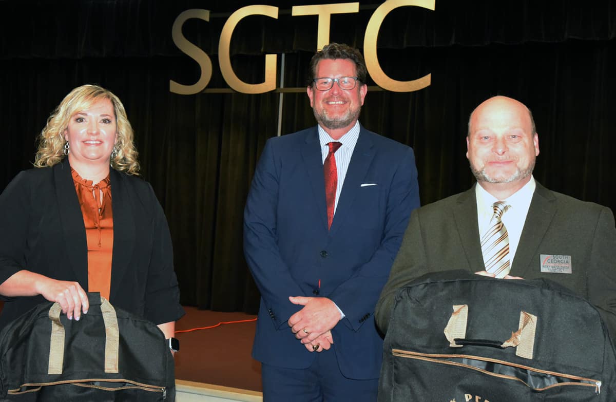 South Georgia Technical College 2021 GOAL winner Dawn Ammons (l to r) is shown above with SGTC President Dr. John Watford and SGTC Rick Perkins Instructor of the Year Chef “Ricky” Ludwig Watzlowick and the travel bags from TCSG at the SGTC Board of Directors meeting recently.