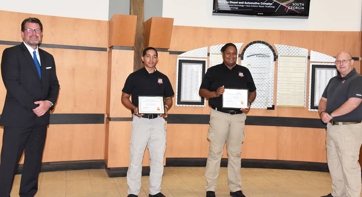 South Georgia Technical College President Dr. John Watford (left) is shown above presenting the Lt. Michael Sangster Law Enforcement Academy Scholarship to Nasier A. Vazquez and Alicia Childs. Vazquez also received the Academic Achievement and Top Gun awards for the class and Alicia Childs was the Class Representative voted on by her peers. Also shown is Law Enforcement Academy Director Brett Murray.
