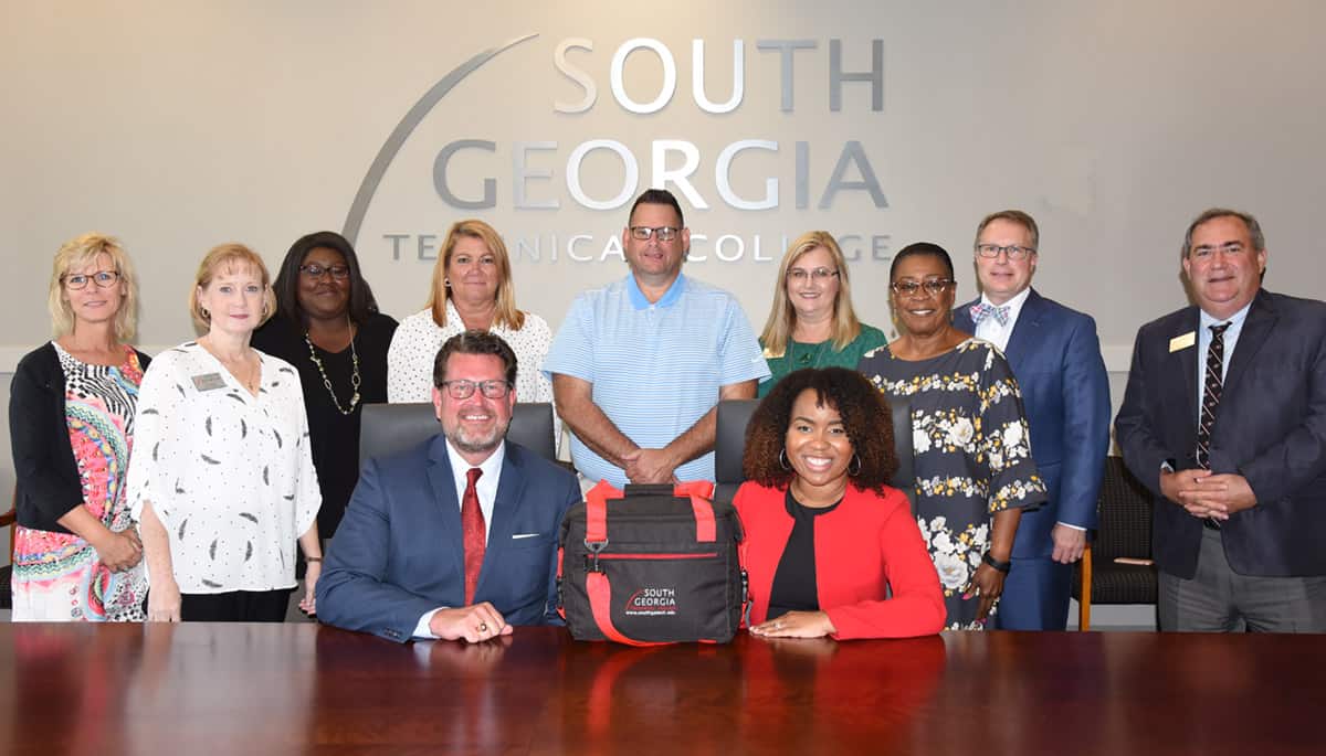 South Georgia Technical College President Dr. John Watford (seated left) is shown above with new Sumter County Chamber President and CEO Amber Batchelor (seated right) during the meeting with the college’s senior leadership team and tour of the campus. Shown standing (l to r) are Dean of Enrollment Management Julie Partain, Vice President of Administrative Services Lea Coe, Vice President of Student Affairs Eulish Kinchens, Vice President of Facilities, Adult Education, and WIO Karen Werling, Athletic Director James Frey, Director of Business and Industry Services Michele McGowan, Director of Career Services Cynthia Carter, Vice President of Academic Affairs David Kuipers, and Director of Business and Industry Services Paul Farr. Not shown is Vice President of Institutional Advancement Su Ann Bird.