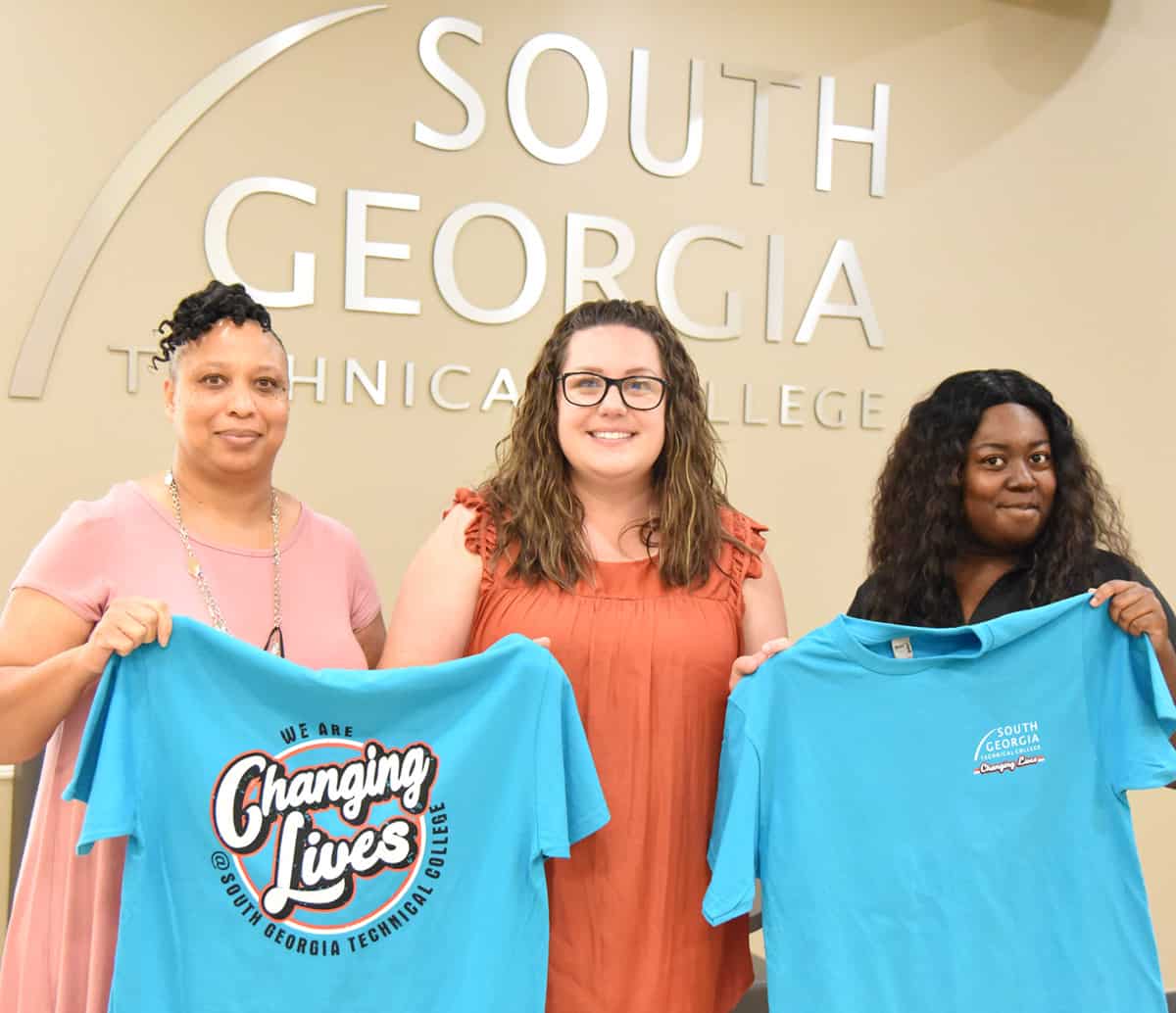 Free “Changing Lives” t-shirts will be available to students registering for Fall Semester at South Georgia Technical College while supplies last. In-person registration will be held July 20th, 2021 in Americus and Crisp County. Shown above (l to r) are SGTC admissions staff Shonda Bodie, SGTC High School Initiatives Specialist Beth Wisham, and SGTC Admissions staff Brittany Rogers showing off the new SGTC “Changing Lives” t-shirts.