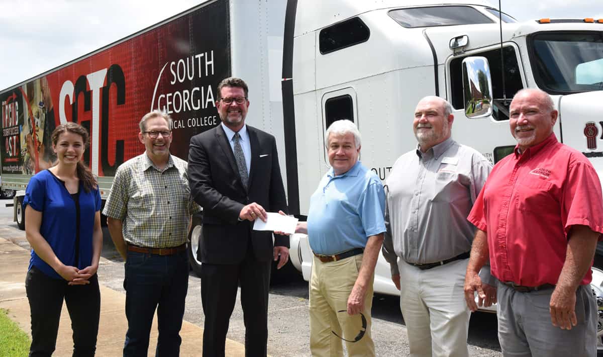 Shown above (l to r) are Tamma Phillips and Kirk Lyman-Barner of Client First Insurance Solutions along with SGTC President Dr. John Watford accepting a donation for Commercial Truck Driving scholarships from Jody Wade of Client First Insurance Solutions with SGTC Commercial Truck Driving Instructors Robert Cooks and Ken Hair.