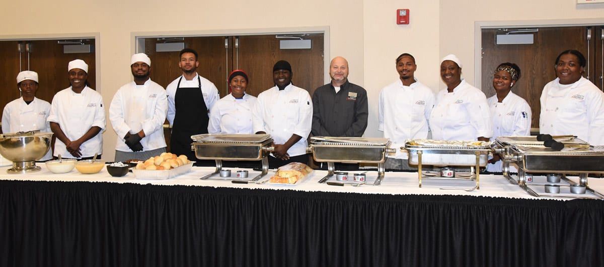 Chef Ricky Watzlowick (right) is shown above with some of the Americus Culinary Arts students who helped with the TechForce Silent Auction.