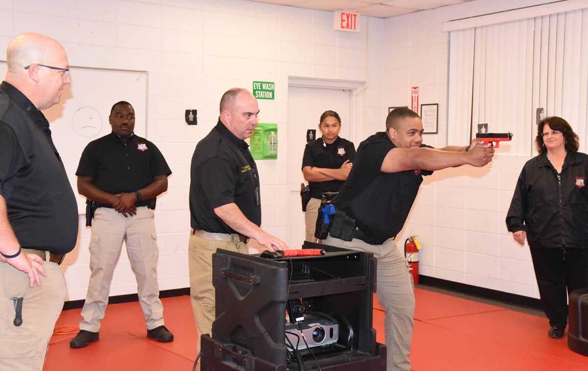 South Georgia Technical College Law Enforcement Academy Director Brett Murray is shown above (l to r) with LEA cadet Richard Franklin, Firearms Trainer Lt. Tony Bobbitt, LEA Cadet Julie Soto, and LEA Cadet Marcellous Deshun using the simulator for a judgement training exercise and SGTC Assistant Vice President for Student Affairs Vanessa Wall, who also works with the Law Enforcement Academy training.
