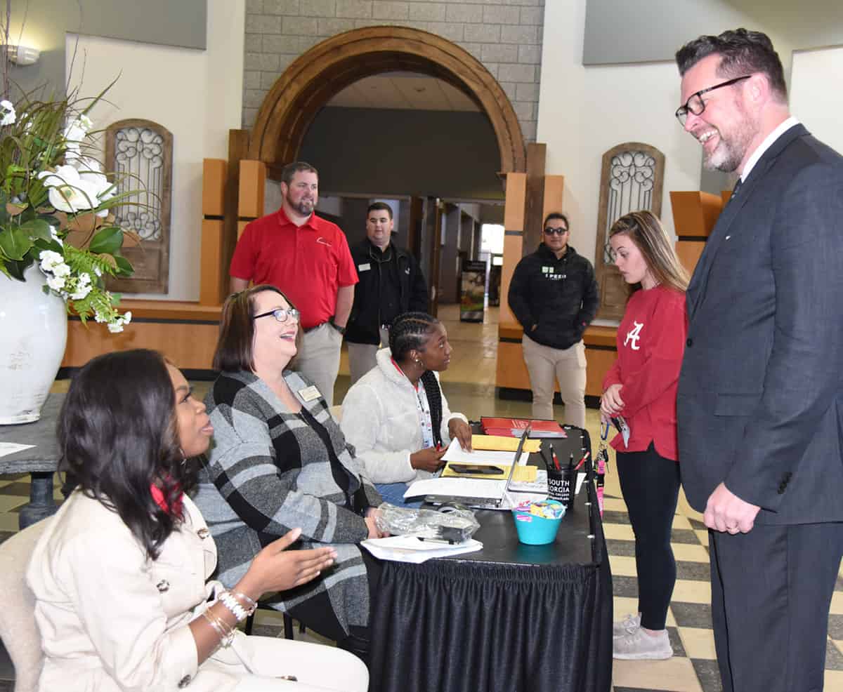 South Georgia Technical College President Dr. John Watford (r) is shown above talking with students and employees during a college registration and orientation session.