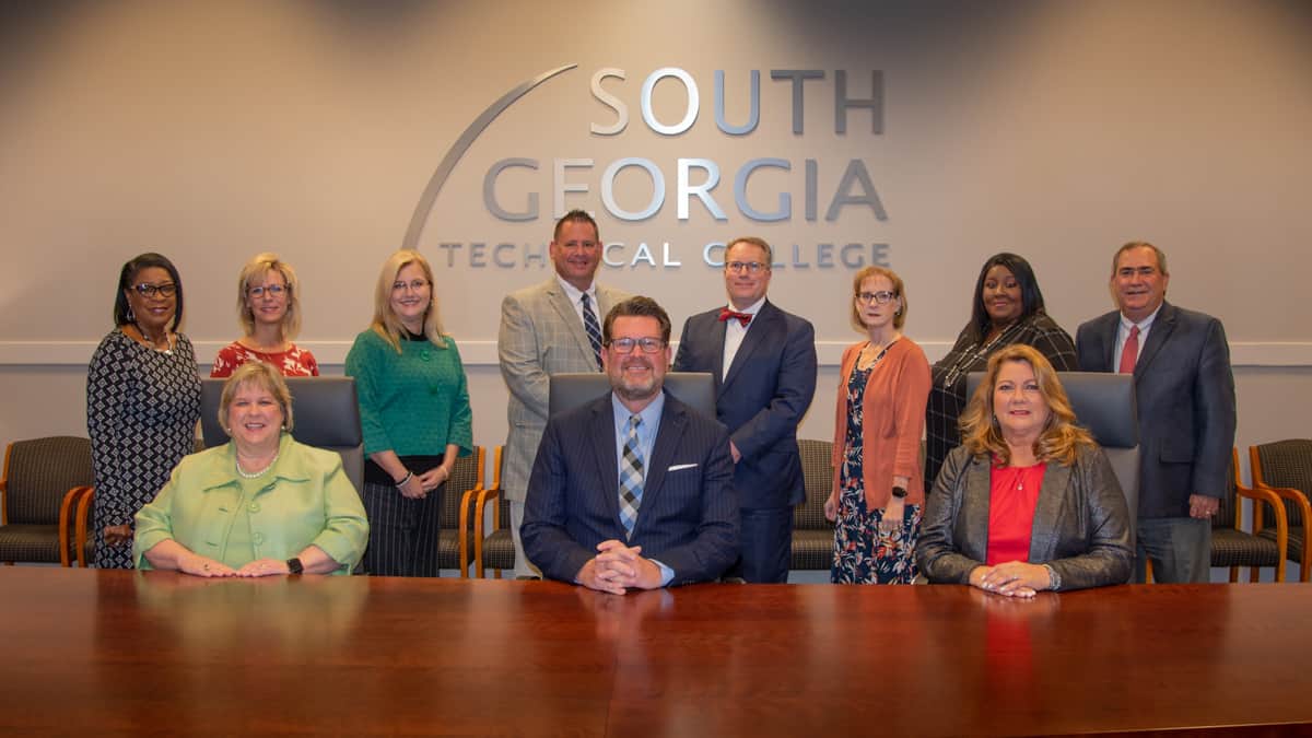 South Georgia Technical College President Dr. John Watford (seated center) is shown above with the members of the SGTC Senior Staff. Seated (l to r) are Su Ann Bird, Vice President of Institutional Advancement, Dr. Watford, and Karen Werling, Vice President of Operations. Shown on the back row (l to r) are: Cynthia Carter, Career Services Director; Julie Partain, Dean of Enrollment Management; Michelle McGowan, Director of Business and Industry Services (Crisp County), Athletic Director James Frey, Vice President of Academic Affairs David Kuipers, Vice President of Administrative Services Lea Coe, Vice President of Student Affairs Eulish Kinchens, and Paul Farr, Director of Business and Industry Services (Americus).