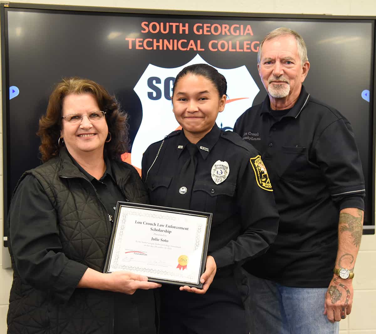 Julie Soto of the South Georgia Technical College Law Enforcement Academy Class 21-02 is shown above (center) with her Lou Crouch Law Enforcement Academy Scholarship award. Shown with Crouch is SGTC Assistant Vice President of Student Affairs and Law Enforcement Academy instructor Chief Vanessa Wall (left) and Lou Crouch (right).
