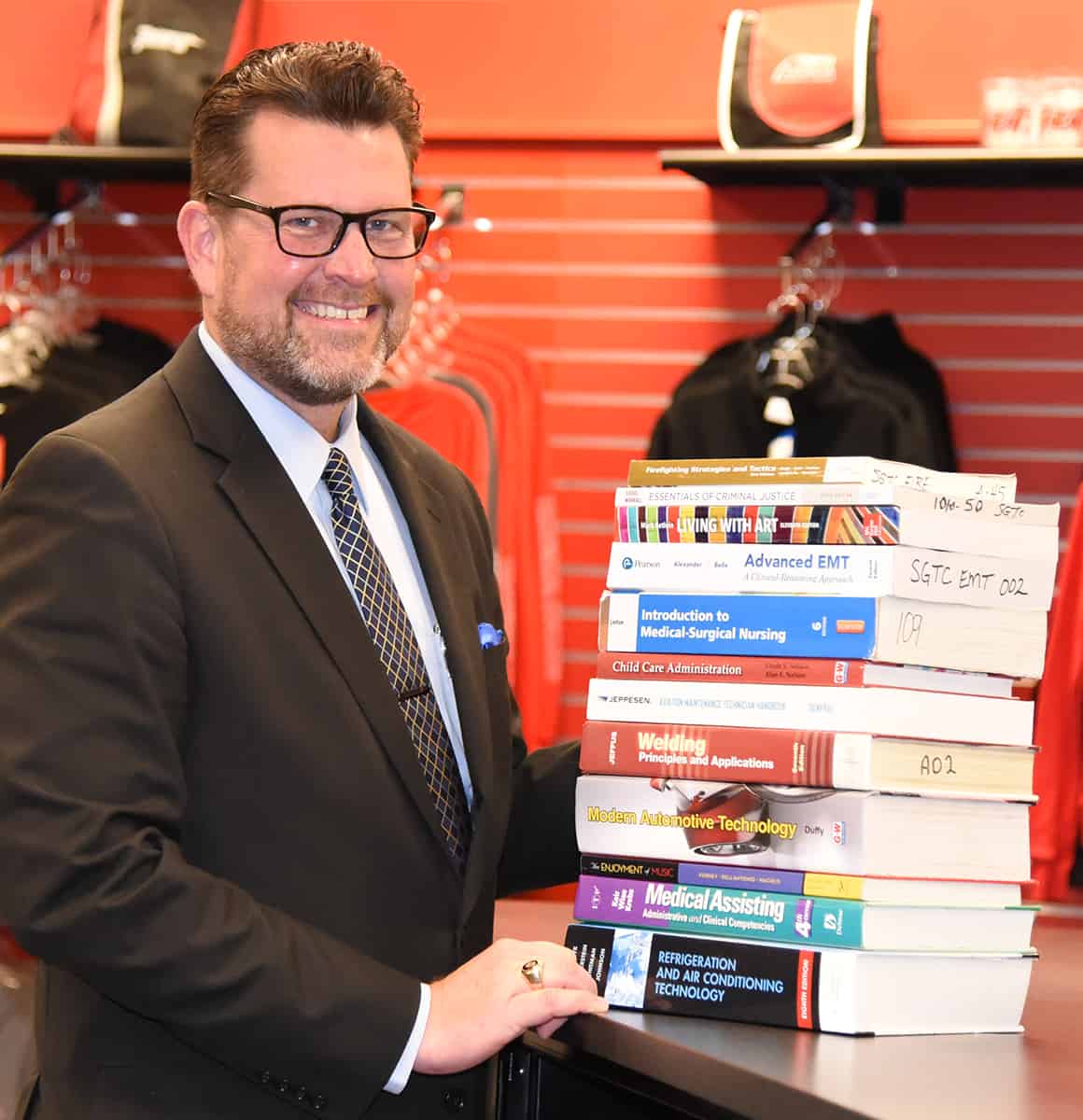 Shown above is South Georgia Technical College President Dr. Watford with a representative stack of college textbooks that are provided for students to use at no cost at SGTC when they enroll for Spring semester. Classes start January 12th. The New Year is a great time to look at expanding or exploring new career options