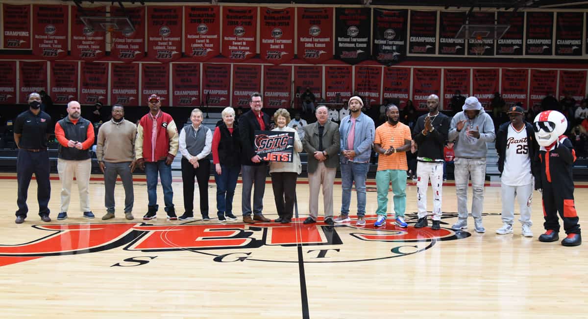 Shown above are eight members of the Jets original basketball team when basketball was restarted back in 2001. They are shown with current President Dr. John Watford, retired President’s Jon Johnson, Sparky Reeves and retired interim President, Vice President of Administrative Services and former Athletic Director Janice Davis along with Steven Wright who was the assistant coach for the Jets in 2001 – 2002. He later became the head coach and athletic director. Sherrill House is also shown. Her late husband Bob House, who was the Director of Business and Industry Services in 2001 named the Jets as part of a contest. The players who returned included Roger Chisolm, Travis Tullis, Jay Turner, Terry “TJ” Brunson, Sylvester Small, Cornelius Goldwire, Mario Harris, and Demetrius Colson. Jason Ward and Steven Hall were unable to attend.