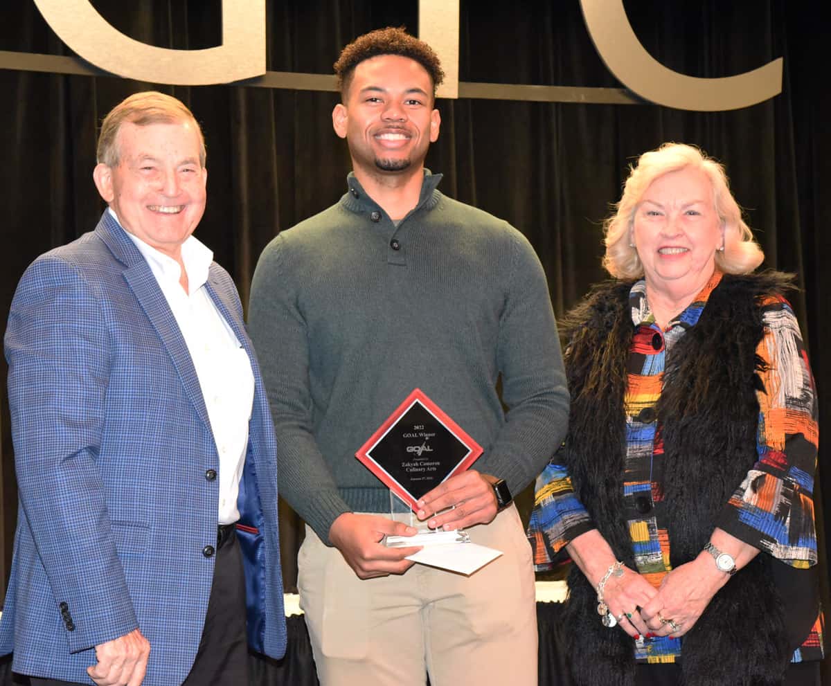 South Georgia Technical College President Emeritus Sparky Reeves (l) and Allene (right) are shown above presenting a scholarship check to 2022 GOAL winner Zakyah Cameron (c).