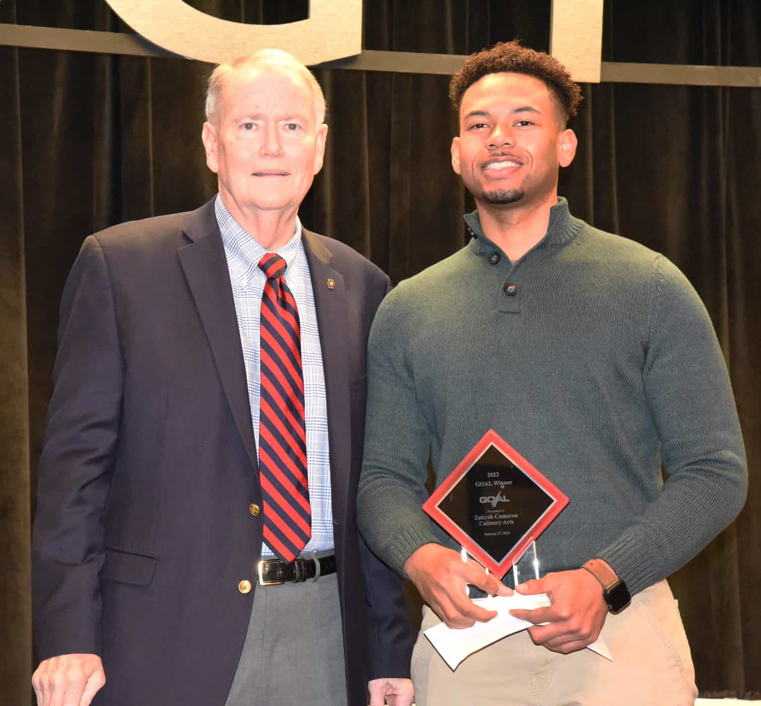 Americus Rotary Club member and Past President Don Smith (l) is shown above presenting a check from the Rotary Club to Culinary Arts student Zakyah Cameron (r), who was selected as the SGTC 2022 GOAL student of the year.