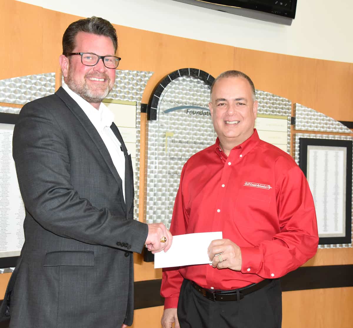 Rick Garcia, President/CEO of Gulf Coast Avionics Corporation in Lakeland, FL, is shown above (on the right) presenting a check for the new endowed scholarships at South Georgia Technical College to President Dr. John Watford (shown on left).