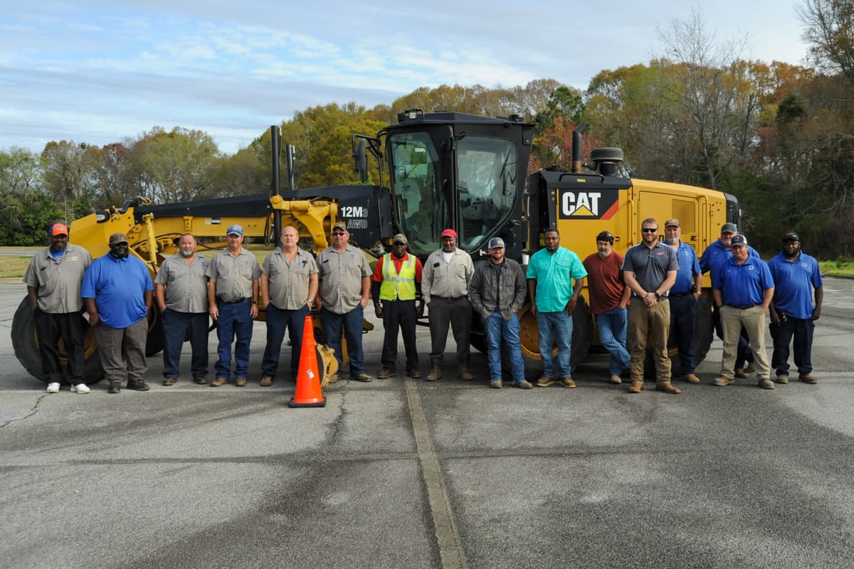SGTC CAT Instructor Kyle Hartsfield (fifth from right) recently led a classroom training session for motor grader operators at the SGTC Crisp County Center.