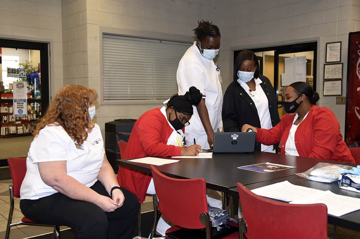 SGTC Practical Nursing instructor Jennifer Childs (left) looks on as her students prepare to register donors at the recent American Red Cross blood drive on the SGTC Americus campus.