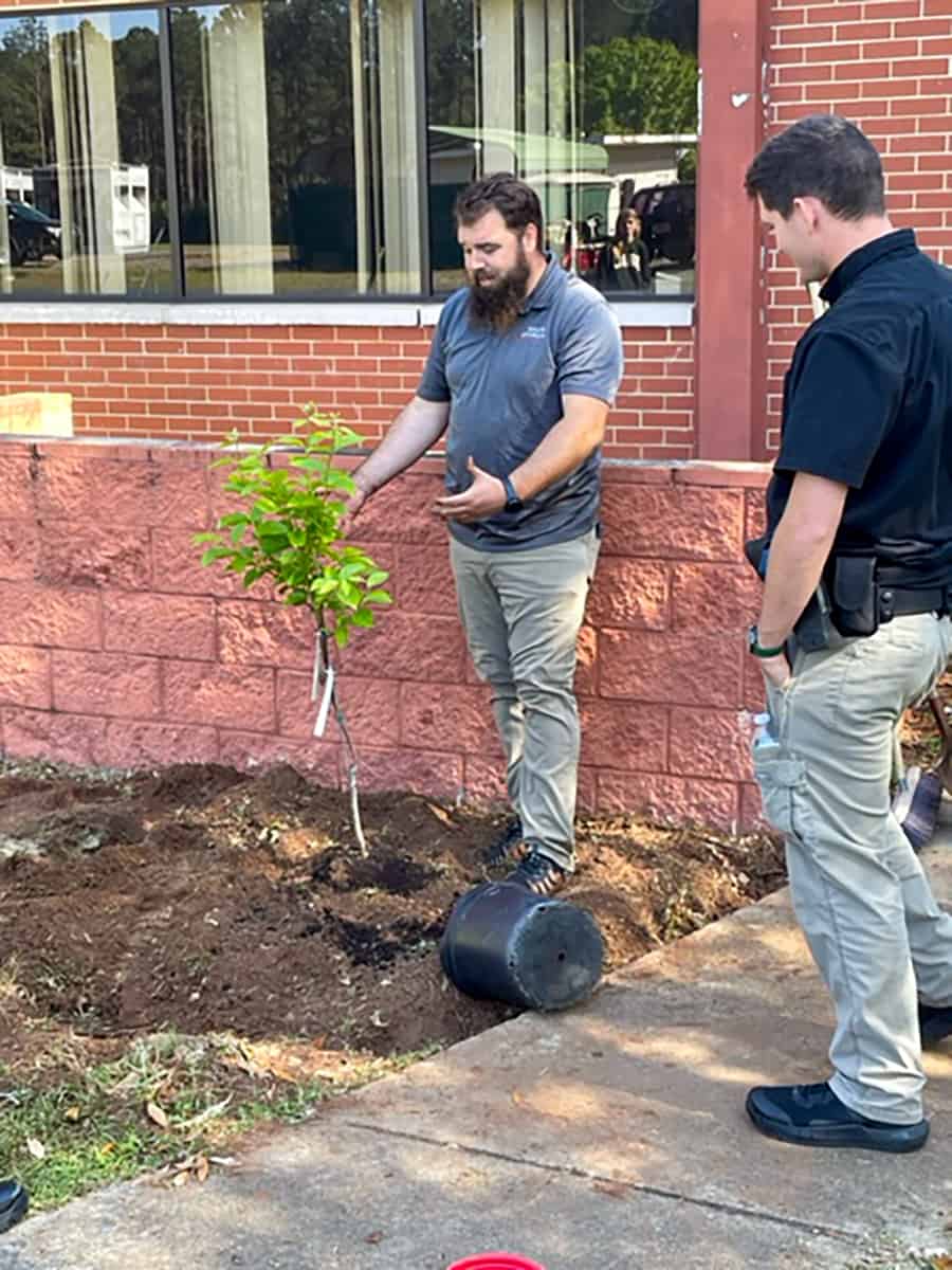SGTC Horticulture instructor Brandon Gross (center) led students, faculty and staff in planting trees to celebrate Earth Day.