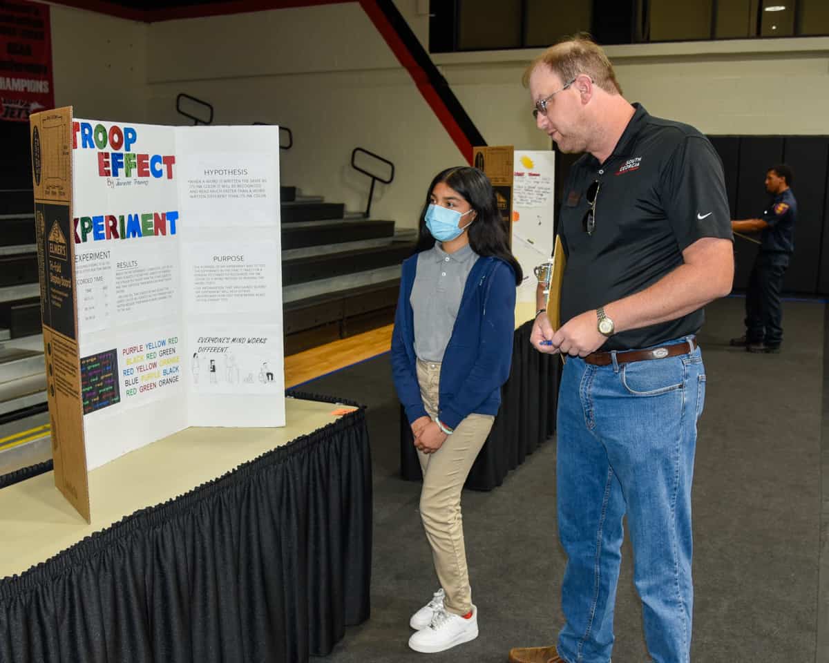 South Georgia Technical College Aircraft Structural Technology instructor Jason Wisham (right) interviews Jeanette Trevino of Macon County Middle School as part of the judging in the Chattahoochee-Flint RESA Science Fair.