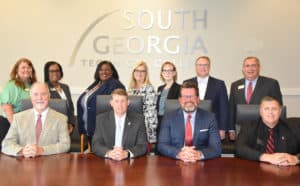 Technical College System of Georgia (TCSG) Deputy Commissioner Dr/ Ray Perren, TCSG Commissioner Greg Dozier, SGTC President Dr. John Watford, and TCSG Assistant Commissioner Mark Peevy are shown above (seated l to r) with SGTC senior leadership (standing l to r) Karen Werling, Cynthia Carter, Eulish Kinchens, Michele McGowan, Lea Coe, David Kuipers and Paul Farr. Not shown is Su Ann Bird.