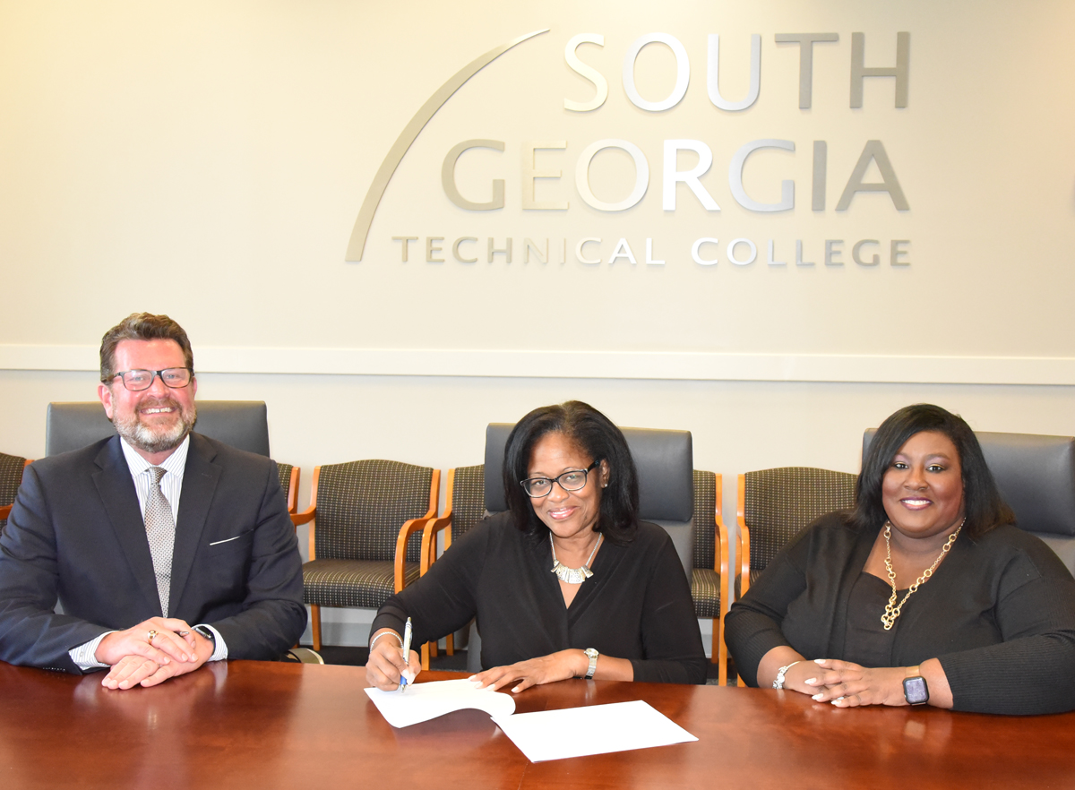South Georgia Technical College President Dr. John Watford (l) is shown above signing the articulation agreement with DeVry Dean of Campus and University Partnerships Dawn Moore and SGTC Vice President of Student Affairs Eulish Kinchens, who is a DeVry alumnus.