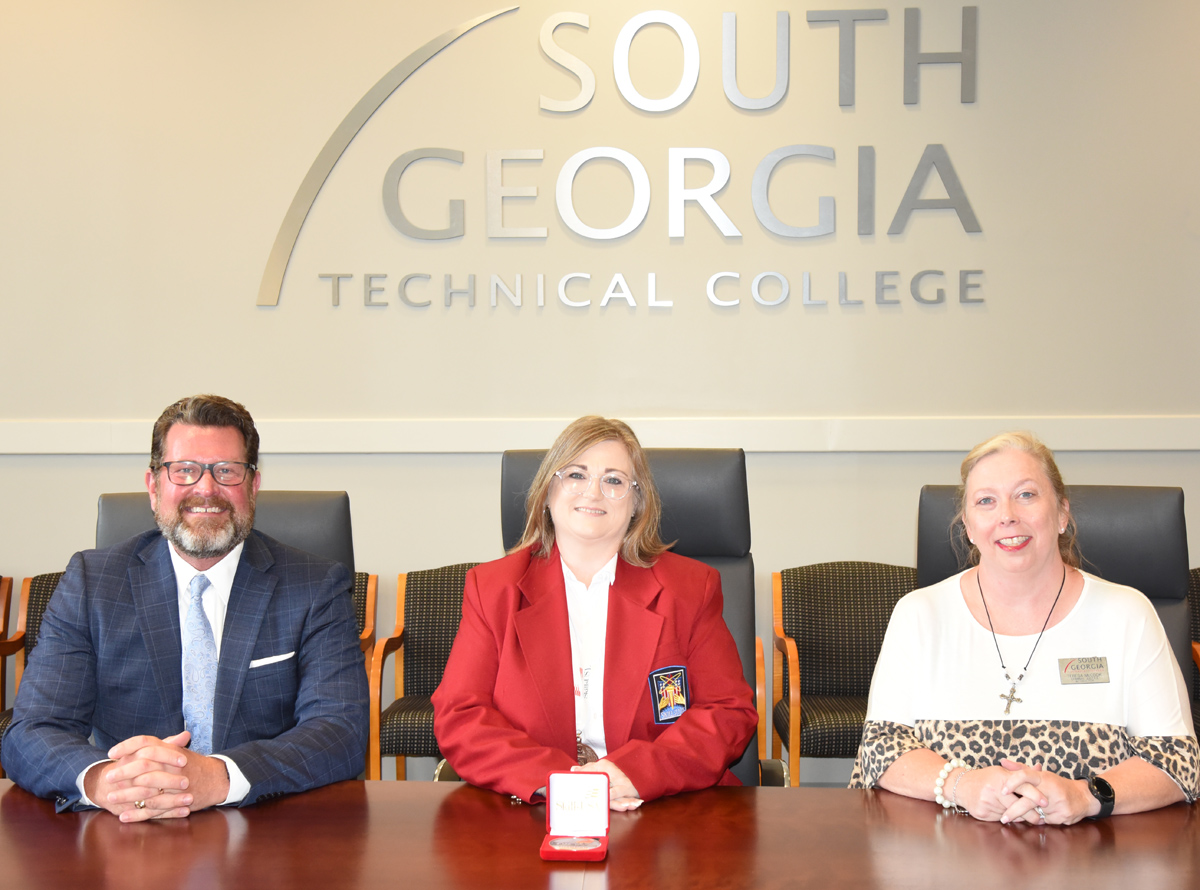 South Georgia Technical College President Dr. John Watford is shown above (l to r) with SGTC’s Bronze National SkillsUSA winner Kimberly Sadecky and her Criminal Justice Instructor Teresa McCook.