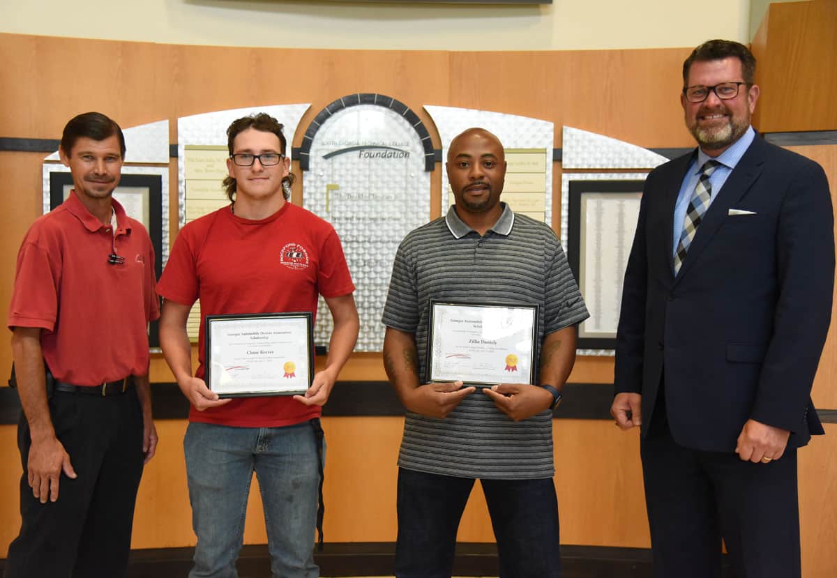 SGTC President Dr. John Watford (right) and SGTC Automotive Technology Instructor Brandon Dean (left) are shown above the GADA Scholarship winners Chase Reeves and Zilly Daniels, Jr.