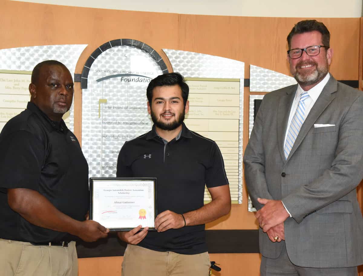 SGTC Auto Collision and Repair instructor Starlyn Sampson is shown above (l to r) presenting Abisai Gutierrez with the GADA Scholarship Certificate while SGTC President Dr. John Watford looks on.