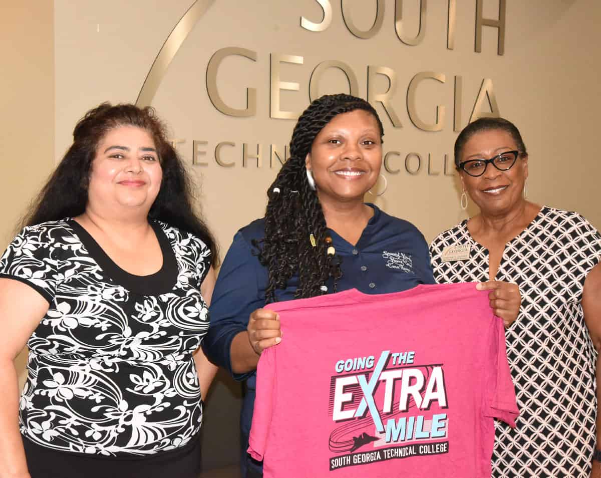 South Georgia Technical College WIOA Coordinator Sandhya Muljibhai is shown above with Ciera Raven presenting her with a “Going the Extra Mile” t-shirt. Cynthia Carter, Director of Career Services at SGTC is also shown.