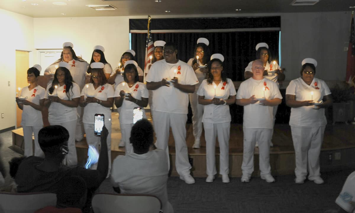 SGTC LPN graduates recite the Nurses’ Pledge after the traditional lighting of the candles during the recent pinning ceremony.