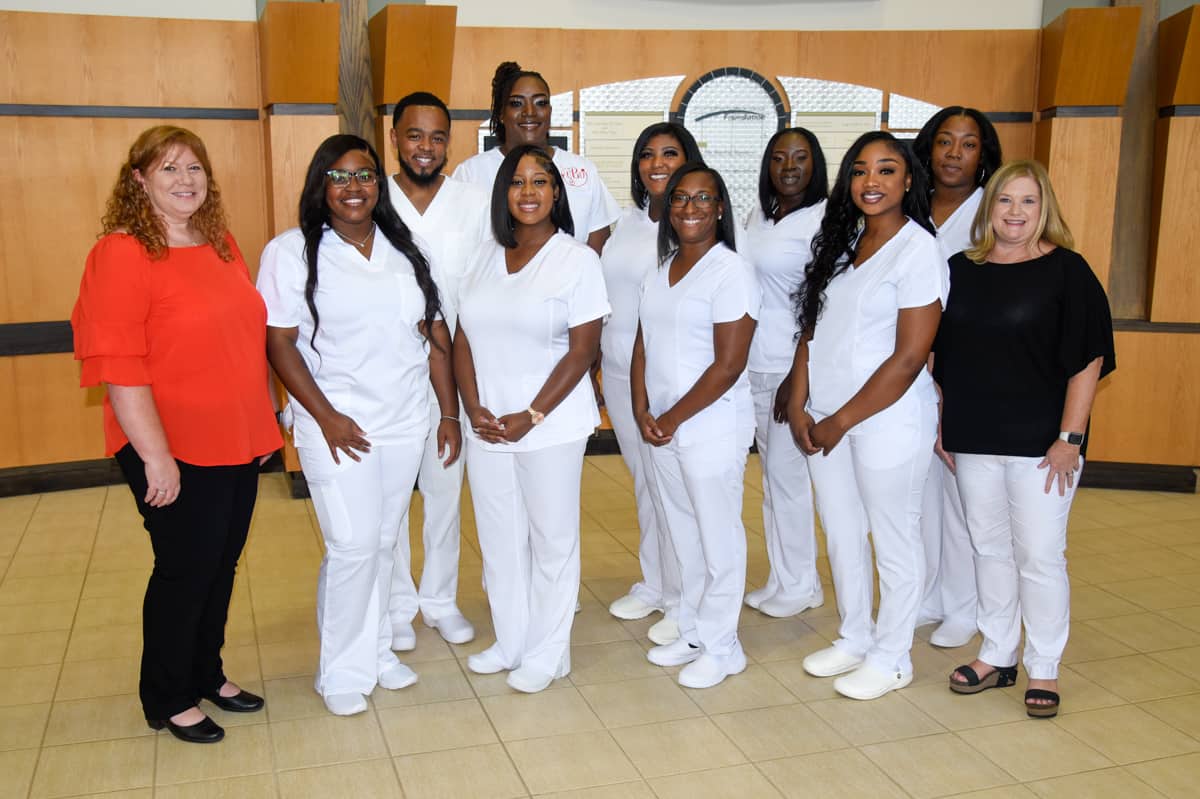 SGTC LPN instructors Jennifer Childs (left) and Christine Rundle (right) are pictured with nine recent graduates of the South Georgia Technical College LPN program who received their nursing pins in a ceremony on the SGTC campus in Americus.