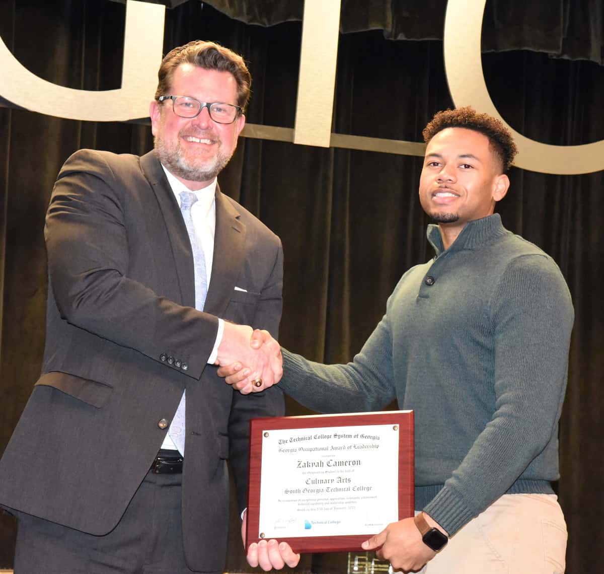 South Georgia Technical College President Dr. John Watford is shown above congratulating Zakyah Cameron on his accomplishments.