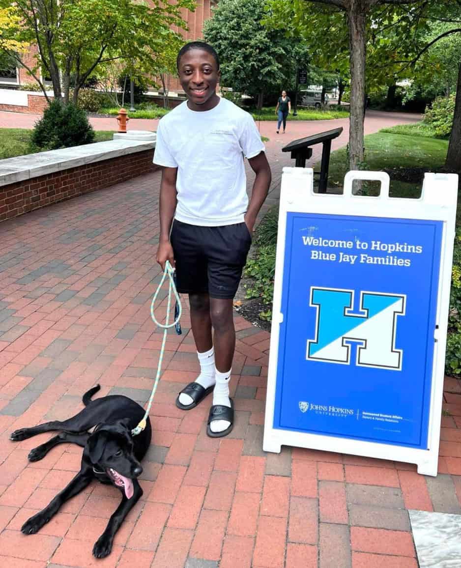 SGTC CIS Alumni Chance Simpson is shown above with his new roommate Piper the Lab, in front of a Johns Hopkins University sign.