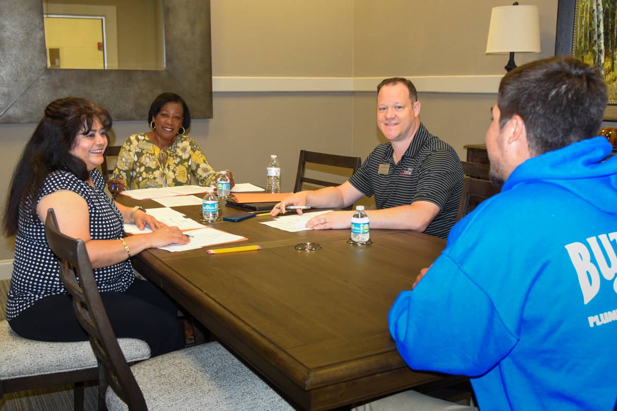 (L-R) SGTC WIOA Coordinator Sandhya Muljibhai, Career Services Director Cynthia Carter, and Assistant Vice President of Student Affairs Josh Curtin conduct a mock interview with Electrical Lineworker Apprentice student Landon Hewett.
