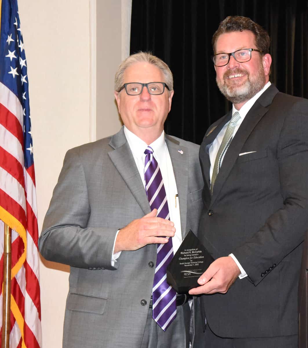 South Georgia Technical College President Dr. John Watford (right) is shown above presenting SGTC’s Champion of Education trophy to RESA’s Richard McCorkle (left).