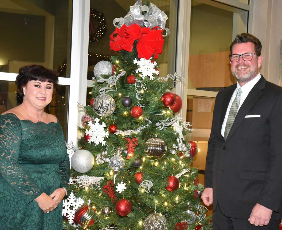 South Georgia Technical College President Dr. John Watford and his wife, Barbara, are shown above by one of the many Christmas trees decorating the John M. Pope Center.