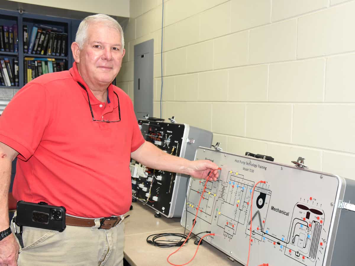South Georgia Technical College Crisp County Center Industrial Electrical and Air Conditioning Technology Instructor Mike Enfinger is shown above looking at one of the trainers that he uses in his classroom to teach students.