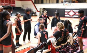 SGTC Lady Jets head coach James Frey is shown above with his team during a timeout.