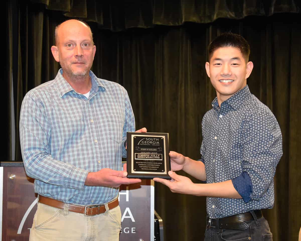 SGTC Industrial Systems Technology instructor Patrick Owen (left) presents a plaque to his student, Joseph Jolly, for being recognized as the college’s overall Student of Excellence.