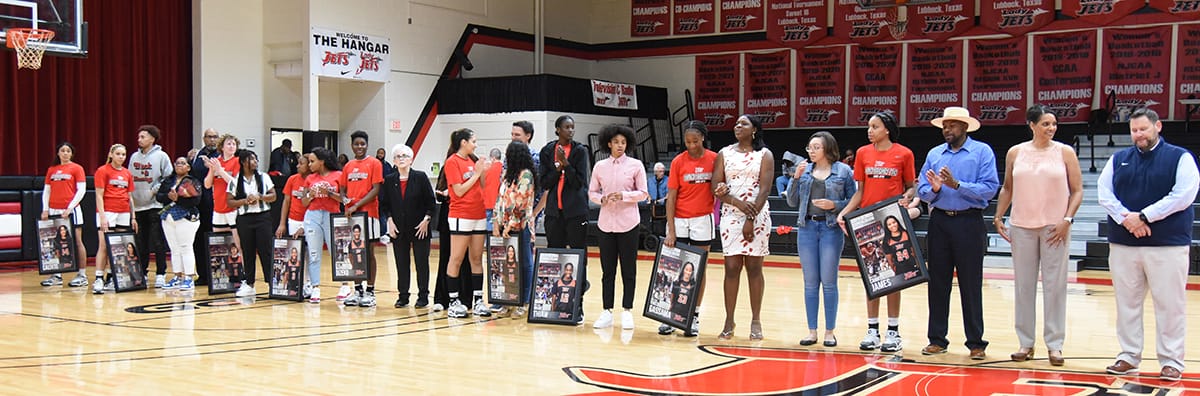 Lady Jets sophomores are shown with their family and friends and SGTC President Dr. John Watford.