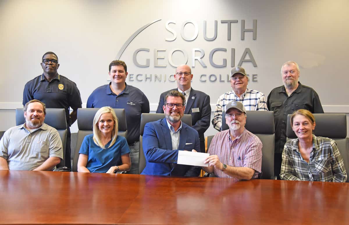 Smarr-Smith Foundation Chairman Donnie McCrary (seated right center) is shown above presenting SGTC President Dr. John Watford (seated left center) with a scholarship check from the Smarr - Smith Foundation to add to the endowed scholarship at the South Georgia Technical College Foundation. Also shown (l to r) seated with Dr. Watford and Donnie McCrary are former chairman Blake Dukes, Ashley Austin, Vice President of the Smarr-Smith Foundation, and Treasurer Jessi Simmons. Standing (l to r) are GSW Chief Michael Lewis, Jimmy Whaley, SGTC Law Enforcement Academy Director Brett Murray, Paul Johnson and Chuck Hanks.