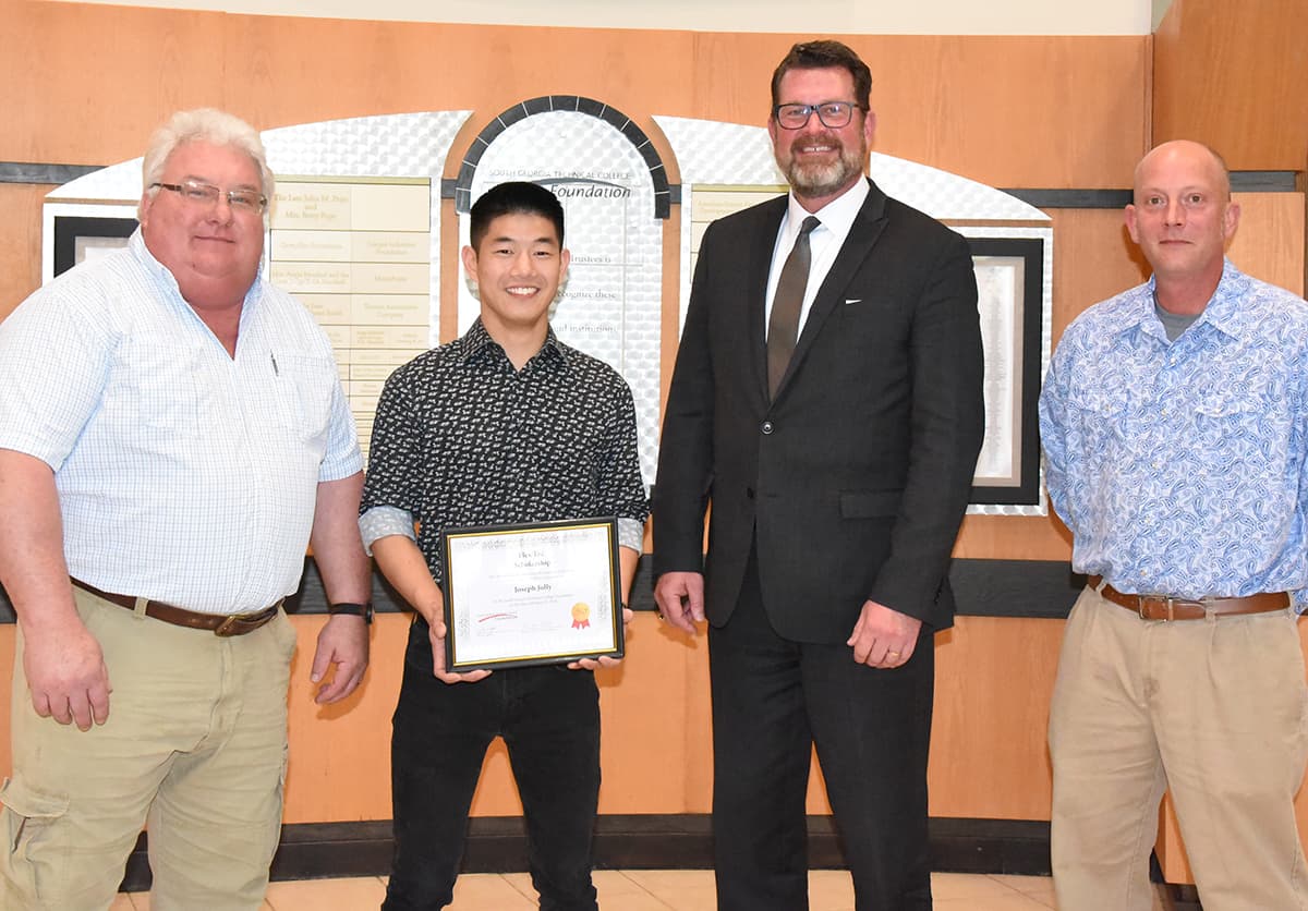 Flex-Tec Plant Manager Rick Barnes is shown above ( l to r) with Joseph Jolly, Flex-Tec scholarship winner, along with SGTC President Dr. John Watford and Industrial Systems Instructor Patrick Owen.