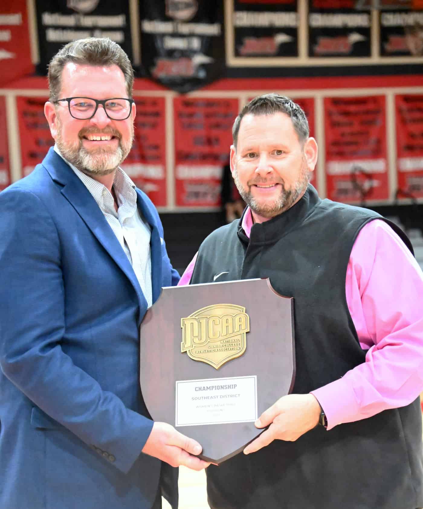 South Georgia Technical College President Dr. John Watford is shown above congratulating Coach James Frey and the Lady Jets on winning the NJCAA Southeast District Championship.