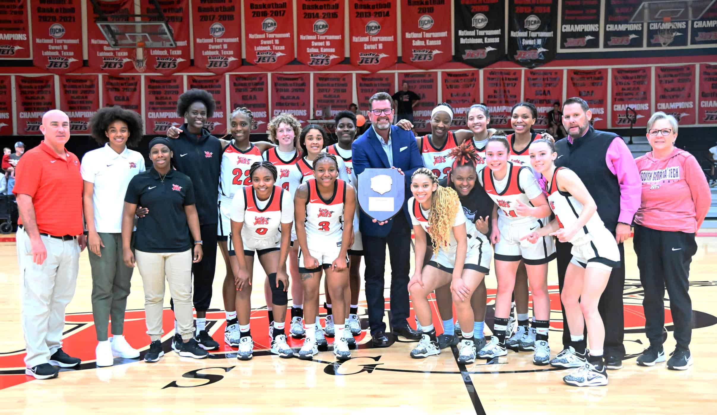 South Georgia Technical College President John Watford is shown above with SGTC Athletic Director and Lady Jets head coach James Frey and the 2022 – 2023 Southeast District Conference champion Lady Jets.