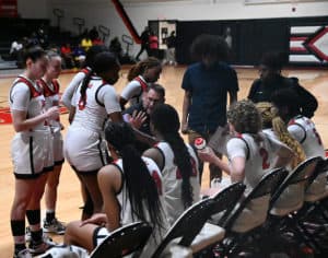 SGTC Coach James Frey is talking to the Lady Jets during a timeout.