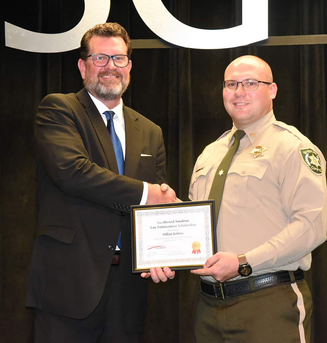 South Georgia Technical College President Dr. John Watford is shown above presenting the Smallwood – Sondron Scholarship award to Dillan Jerkins.
