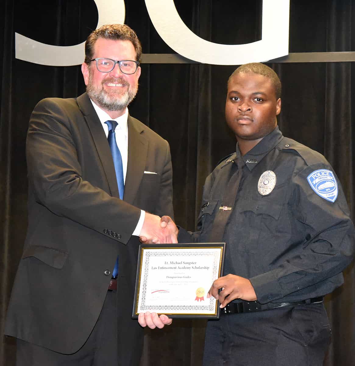 South Georgia Technical College President Dr. John Watford is shown above presenting the Lt. Michael Sangster Law Enforcement Academy Scholarship to Donquavious Gudes.