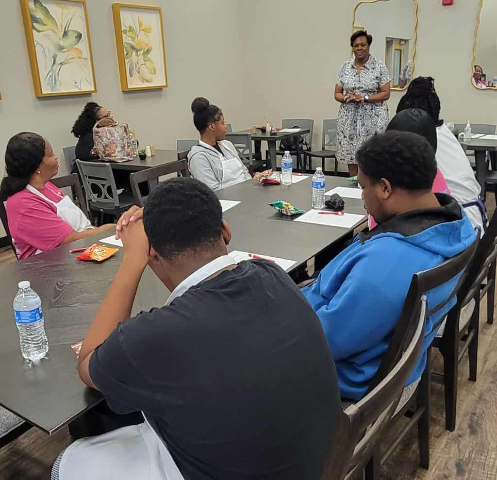 Emily Simpson (standing) discusses work ethics with South Georgia Technical College students during a recent workshop.