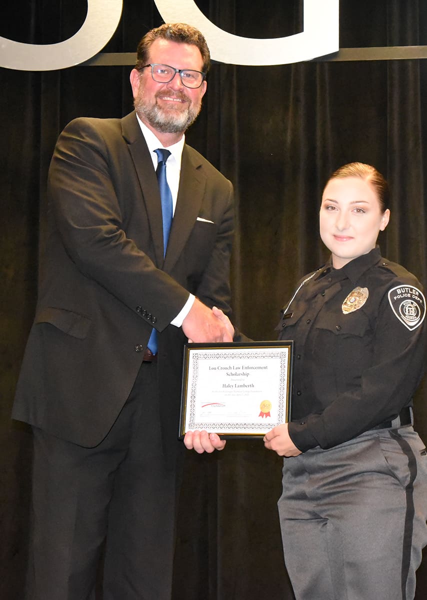 Haley Lamberth of the South Georgia Technical College Law Enforcement Academy Class 23-01 is shown above (right) receiving the SGTC Foundation Lou Crouch Law Enforcement Academy Scholarship award from SGTC President Dr. John Watford.