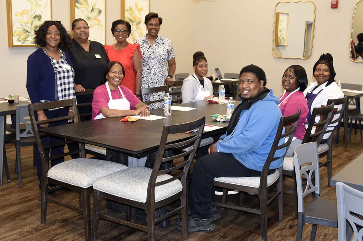 Guest speaker Emily Simpson (standing, center) with SGTC Career Services Director Cynthia Carter, Culinary Arts instructor Corcynthia Monts, and Retention and Coaching Specialist Dr. Deo Cochran (standing r-l) with a group of SGTC students during a recent work ethics workshop on the SGTC campus.